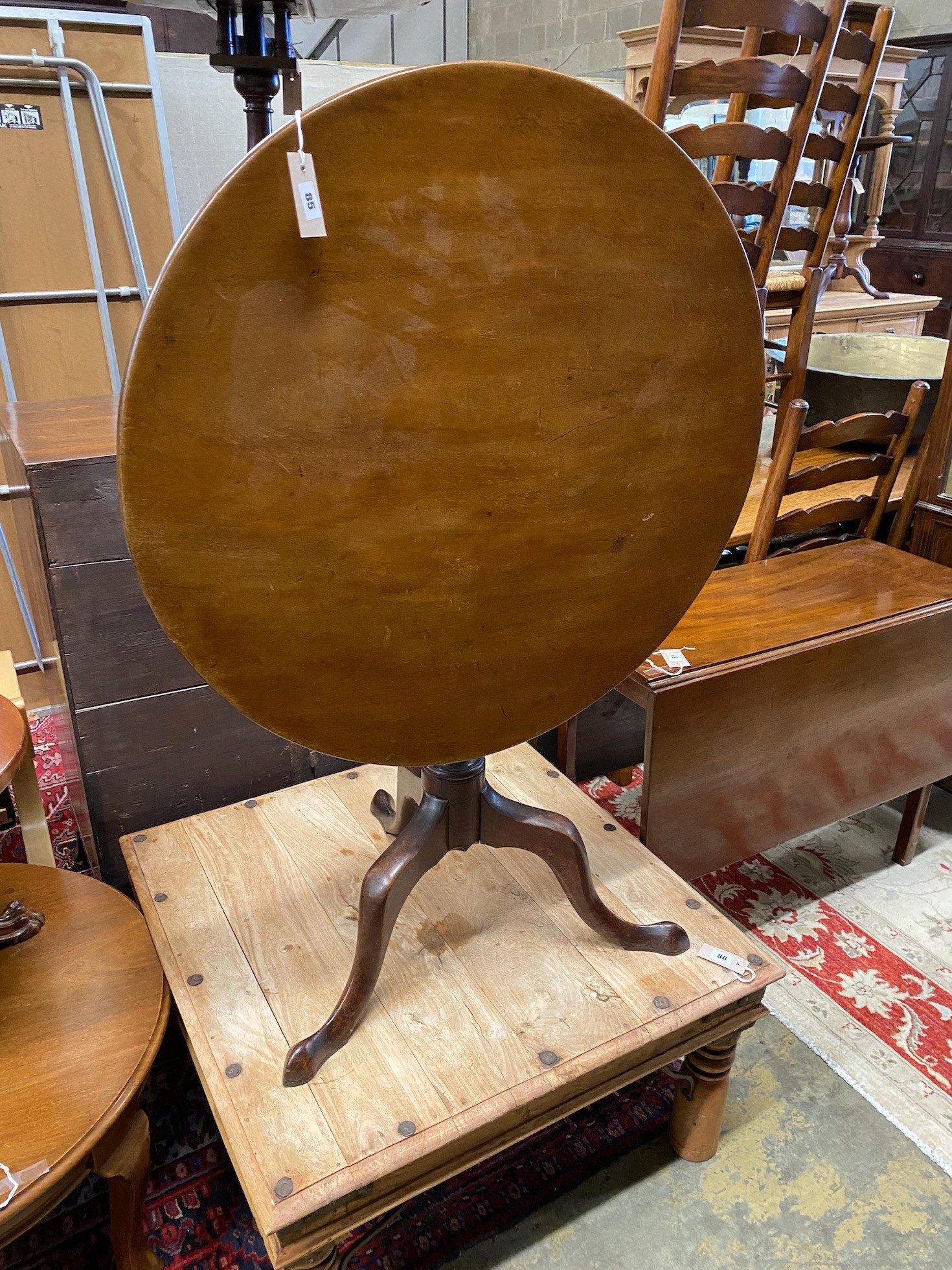 A George III mahogany circular tilt top tripod tea table, diameter 78cm, height 72cm